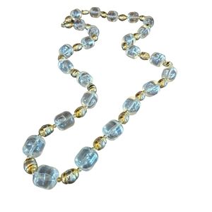 Vintage long clear plastic beaded necklace with gold beaded accent.